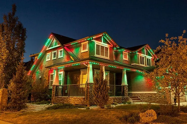 Permanent LED track lighting installed along a home roofline