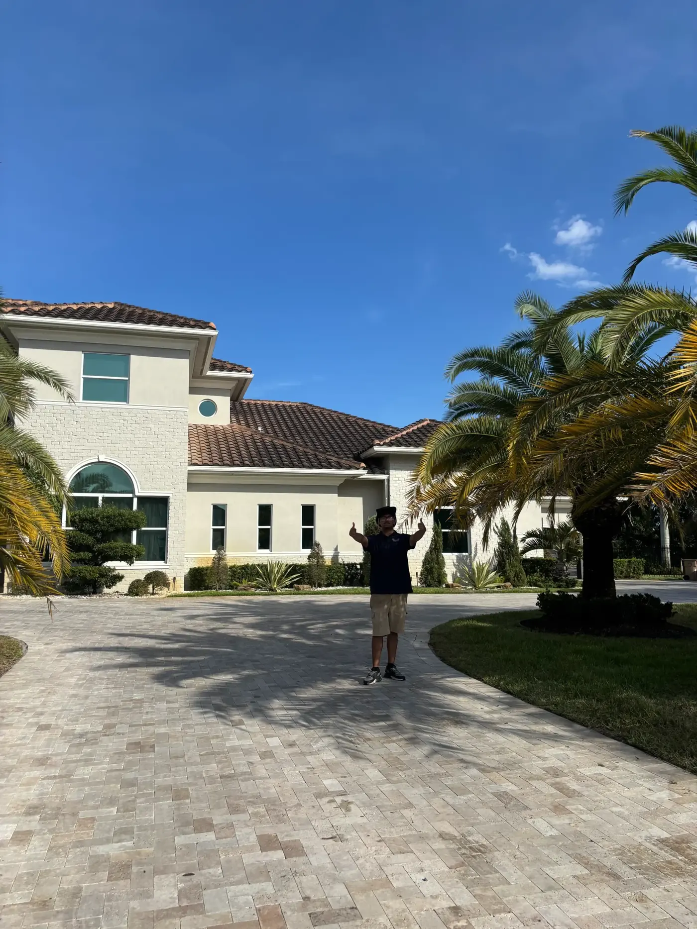 Clean windows on a luxury home with palm trees, serviced by Ledeva